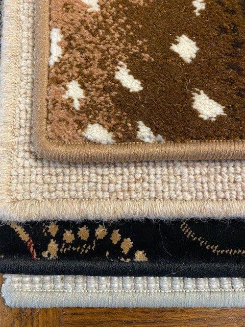 Stacked patterned carpet samples with coordinating serged edges